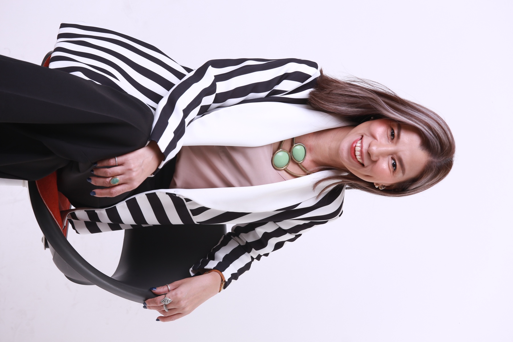 Worakamol Meepiarn smiling in a black-and-white striped jacket
